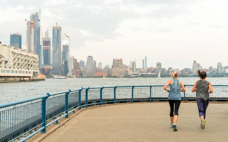 two people jogging on a bridge